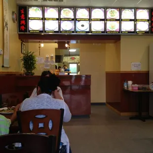 a woman sitting at a table in a restaurant