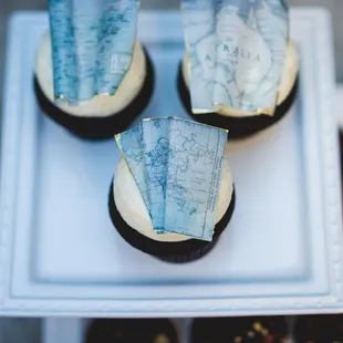 Edible maps with metallic touches on these dark chocolate cupcakes!