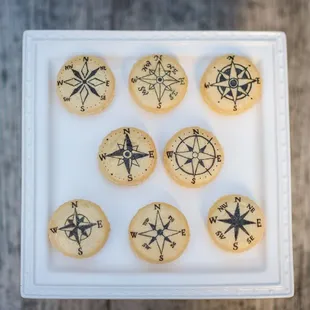 Hand painted compasses on French Macarons.