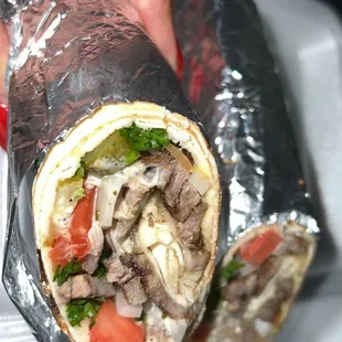 a hand holding a burrito