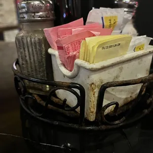 Filthy condiment holder on the table.