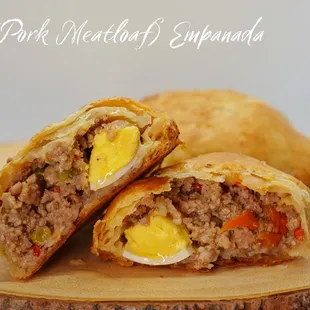 a cut in half sandwich on a wooden plate