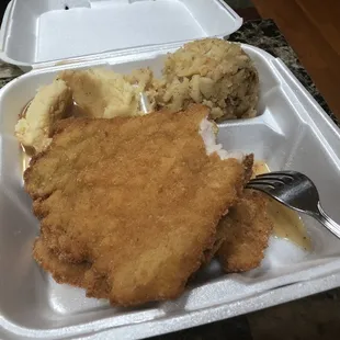 chicken cutlets, mashed potatoes, and mashed potatoes in a styrofoam container