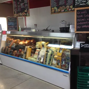 Deli case, next to the Ice Cream case. Hand baskets and carts available.