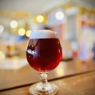 a glass of beer on a bar