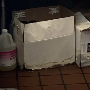 Water damaged rotting boxes of growlers under the bar