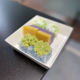 a square plate of colorful desserts