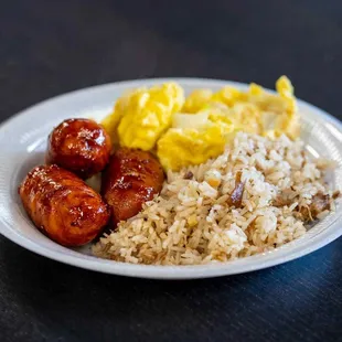 a plate of rice, sausages, and eggs