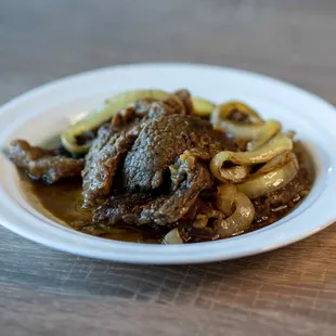 a plate of beef and onions