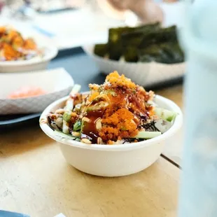 a bowl of food on a wooden table