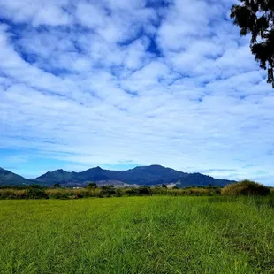 Do you see the silhouette of a pregnant woman laying down in the mountains?