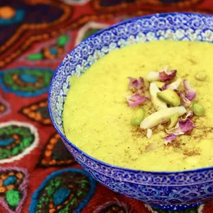 a bowl of soup on a colorful table cloth