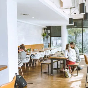 people sitting at tables in a cafe