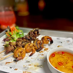 Grilled shrimp and grilled pork skewers, side of our signature lime fish sauce.
