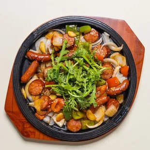 Korean stir-fried sausage on hot sizzling plate