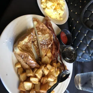 French toast, potatoes, eggs, and bacon