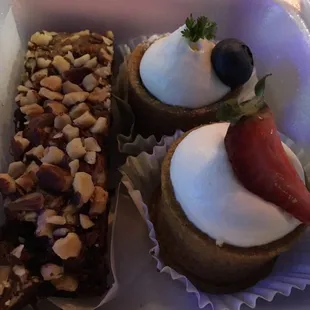 Brownie with lots of nuts, a strawberry and a blueberry tart