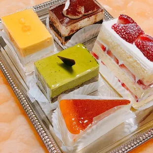 Soufflé cheesecake, matcha mousse cake, strawberry shortcake, mango papaya mousse cake, tiramisu