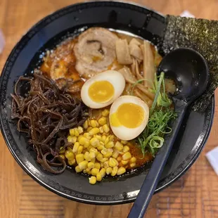 a bowl of ramen and a spoon