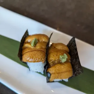 two pieces of sushi on a plate