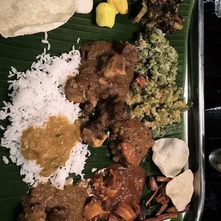 a plate of food on a banana leaf