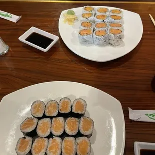 Salmon rolls in the foreground, spicy tuna and spicy salmon rolls in the background.