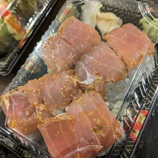 a variety of sushi wrapped in plastic