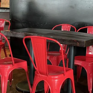 Wood topped tables with fire engine red metal chairs