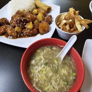 Cup of egg drop soup with wonton &amp; sesame chicken