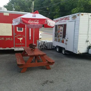a food truck and a picnic table