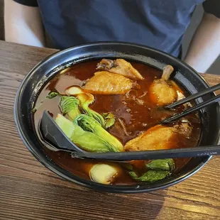 Spicy level 5 vermicelli bowl with chicken on the bone.