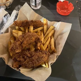 a basket of fried chicken and french fries
