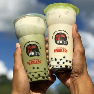 two people holding up their drinks