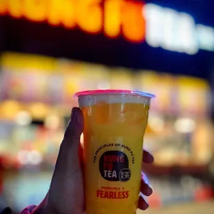 a hand holding a cup of tea