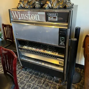 A vintage cigarette machine for decor. This location has been in operation since 1973!