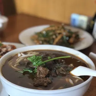 a bowl of soup and a plate of rice