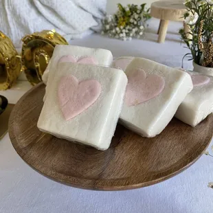 four pieces of white bread with pink hearts