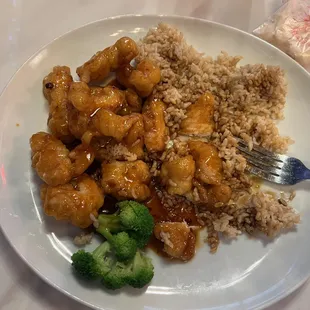 a plate of food with rice and broccoli