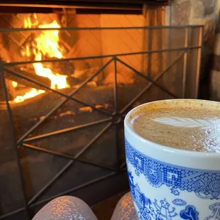 A cozy latte by the fire. Peep my "it could be worse" mug