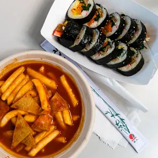 a bowl of soup and a plate of sushi