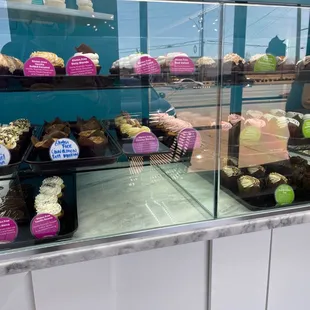 a display case filled with cupcakes