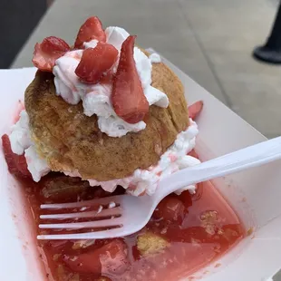 a strawberry shortcake with whipped cream and strawberries