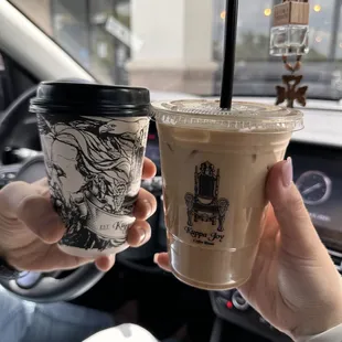 two people holding coffee cups