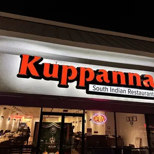 the front of a restaurant at night