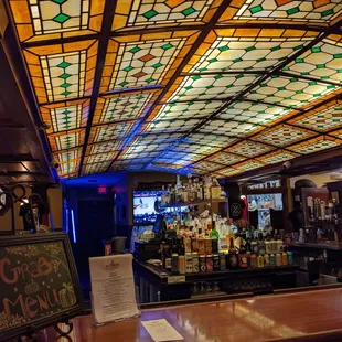 a bar with stained glass ceiling