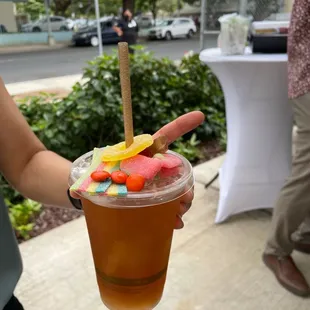 a person holding a cup of ice tea