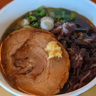 a bowl of soup with meat and vegetables