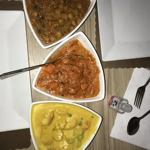 three bowls of food on a table