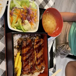 a meal of rice, meat, and vegetables