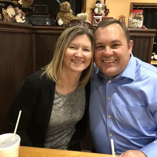 a man and woman sitting at a table